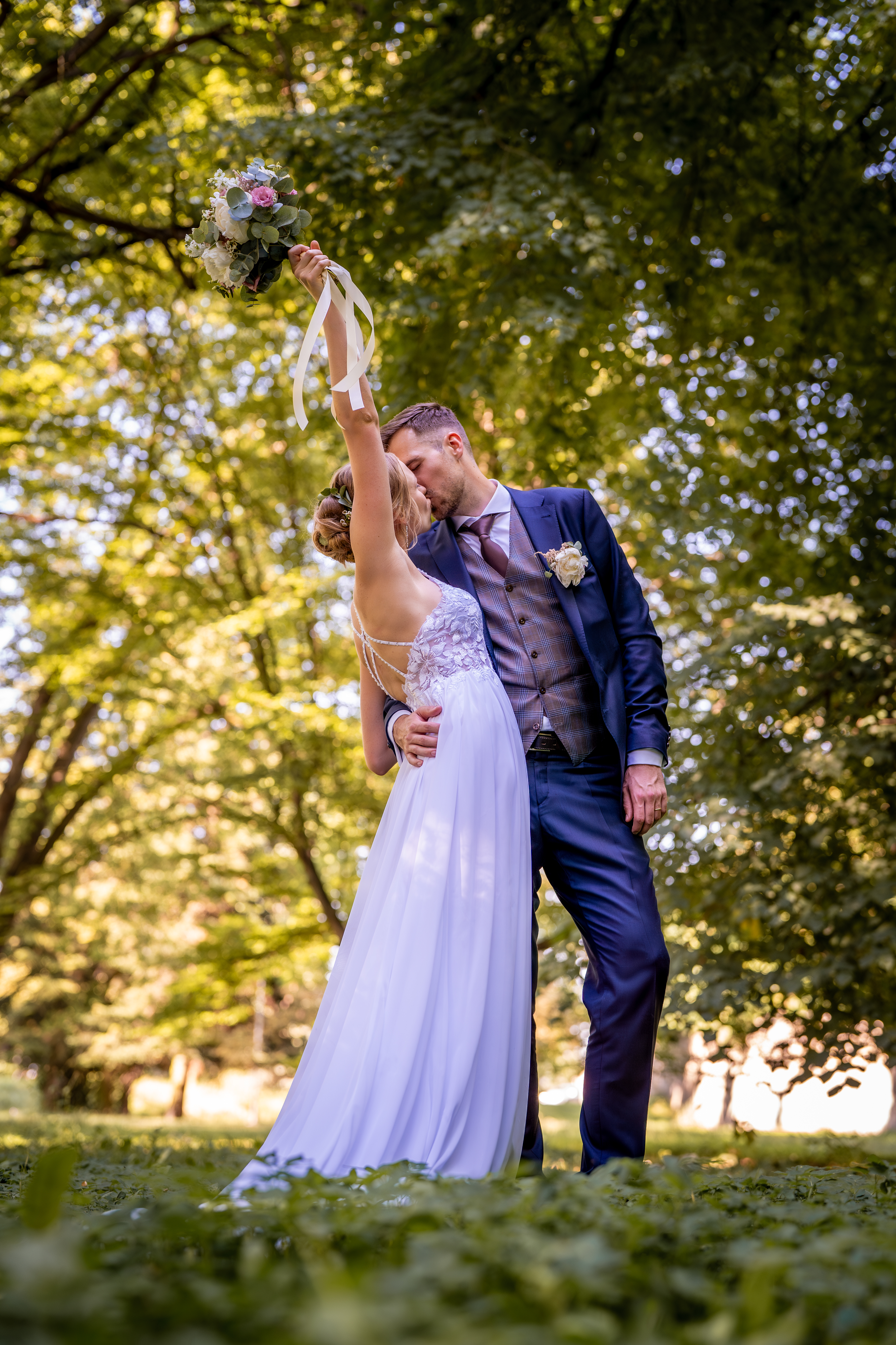 Bride raising bouquet romantic kiss wedding ceremony Czech Republic