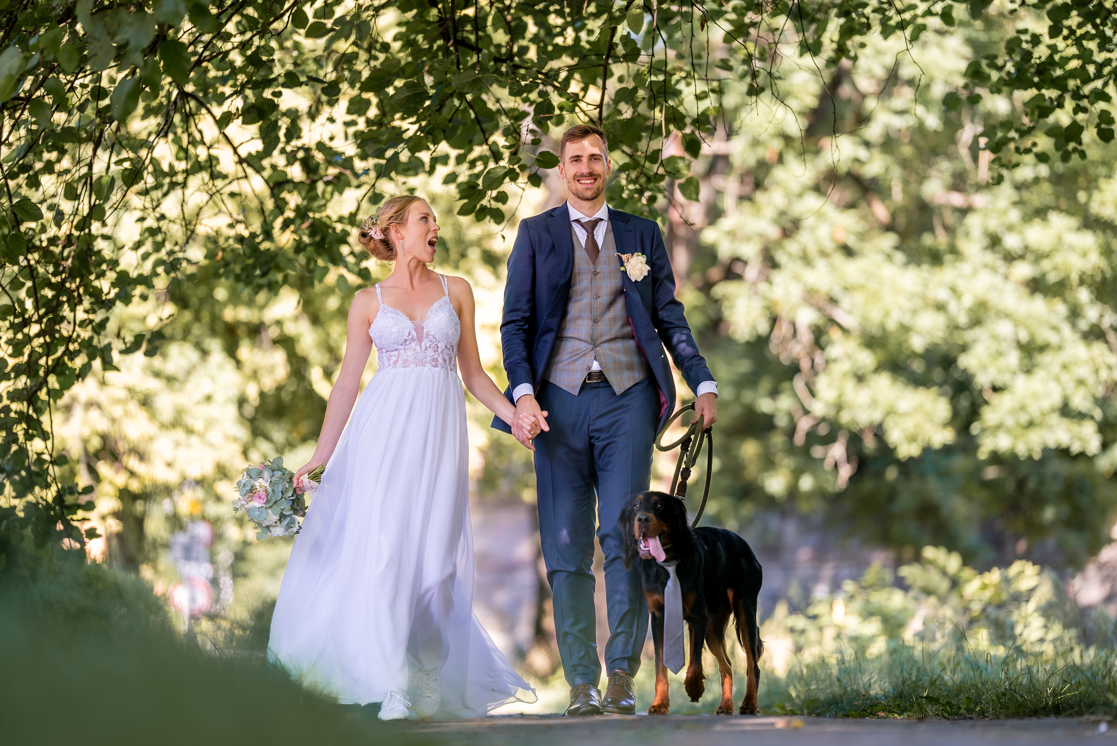 Couple walking with dog relaxed outdoor wedding Czech Republic