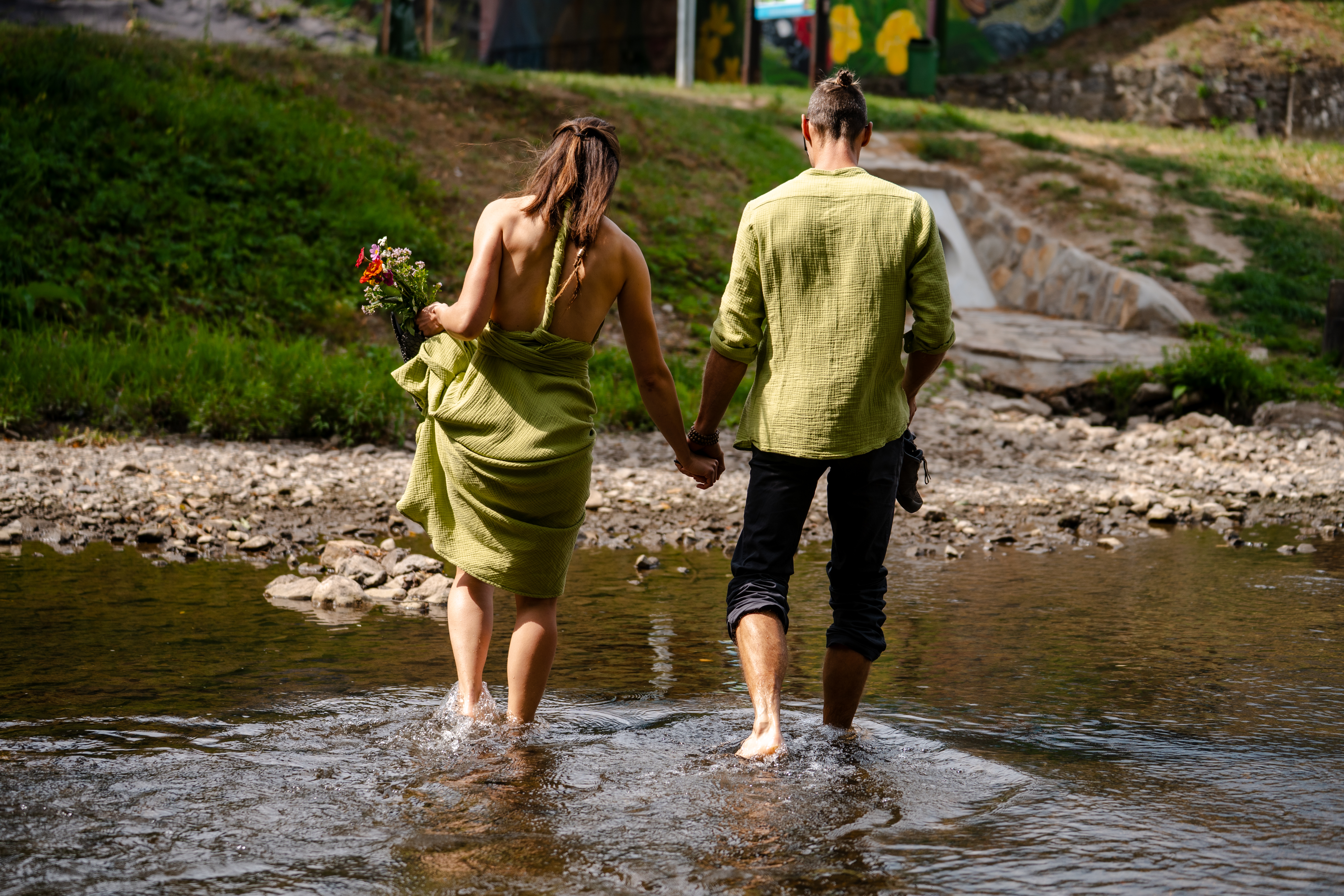 Wedding couple walking along river Prague Czech Republic